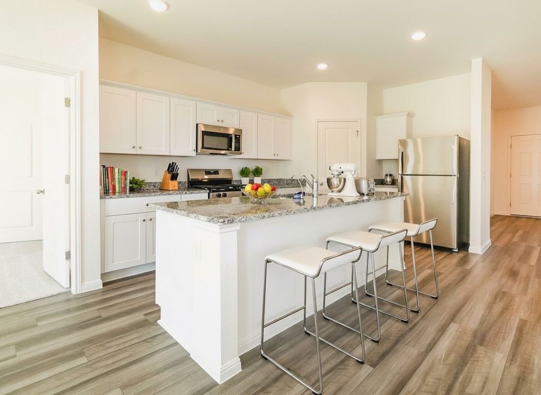 1524 Morris Loop San Marcos, TX 78666 - Photo 5 of 25 a kitchen with white cabinets and refrigerator