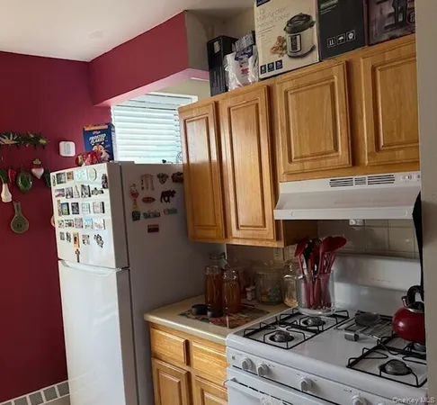 a kitchen with stainless steel appliances granite countertop a stove and a refrigerator
