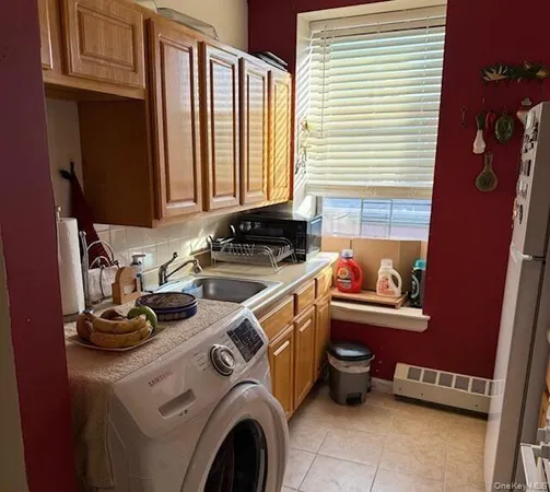 a utility room with sink dryer and washer