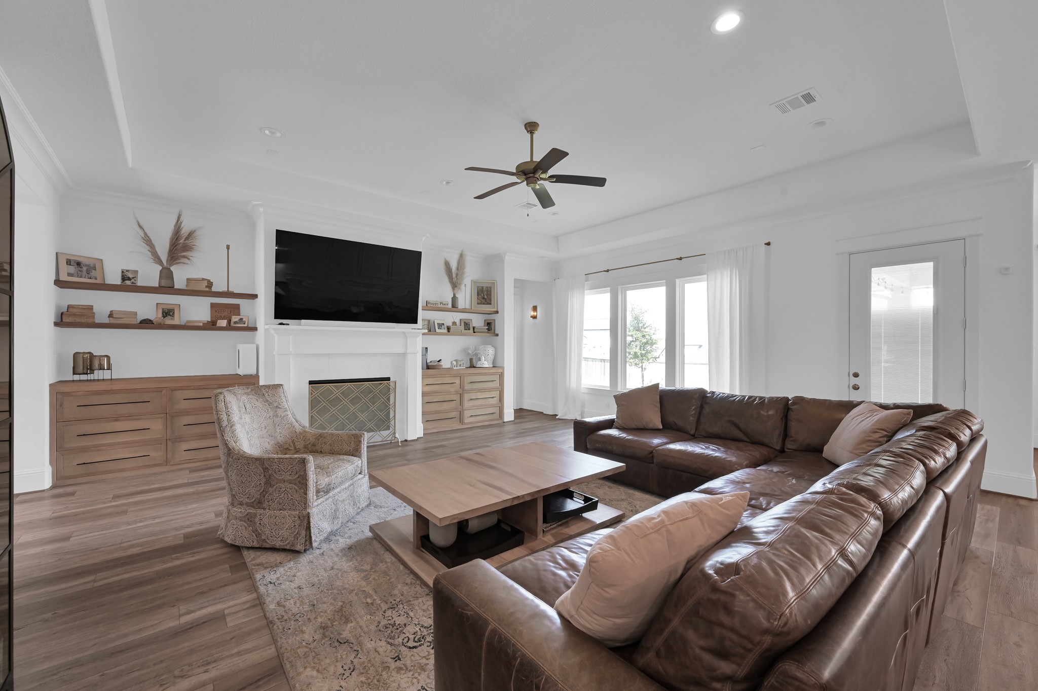 2333 Goldenglade Drive Conroe, TX 77384 - Photo 5 of 45 Settle into this lovely living space with a gas fireplace and custom built-ins and shelving!
