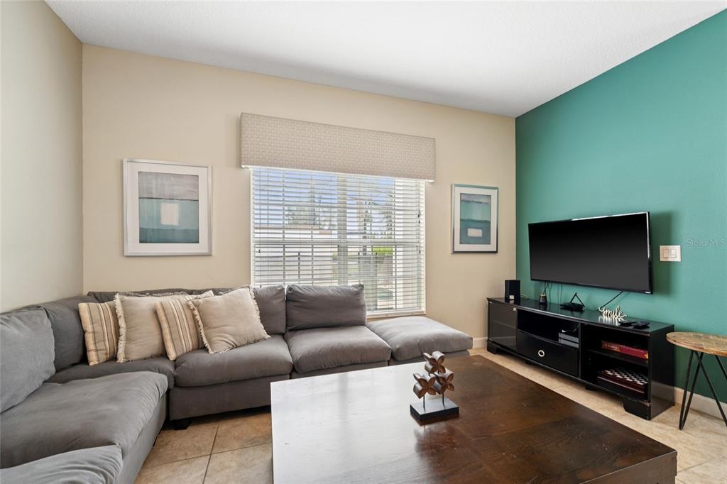 4841 Clock Tower Drive Kissimmee, FL 34746 - Photo 11 of 36 a living room with furniture and a flat screen tv