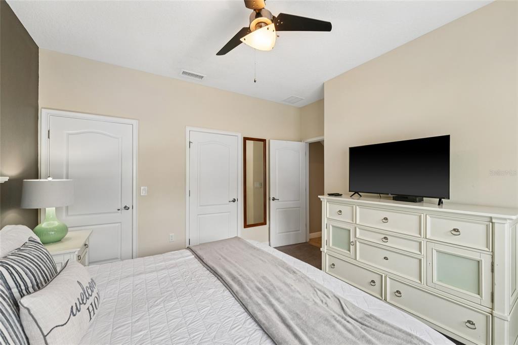 4841 Clock Tower Drive Kissimmee, FL 34746 - Photo 15 of 36 a hotel room with a bed and a flat screen tv