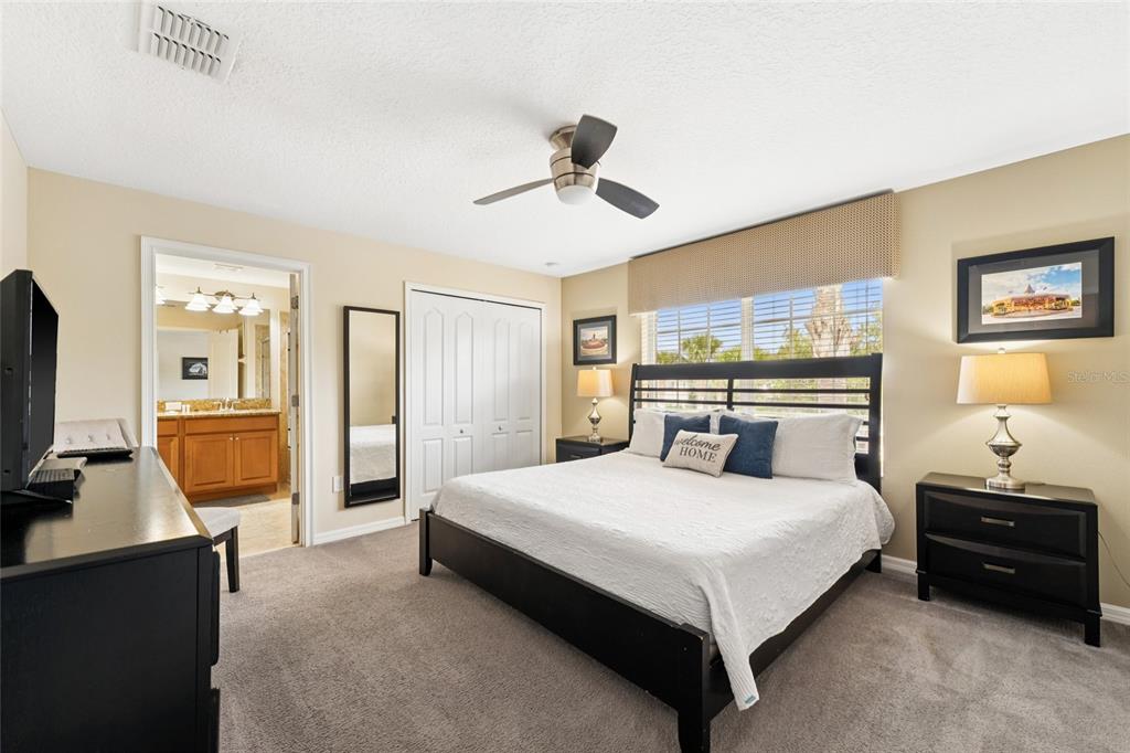 4841 Clock Tower Drive Kissimmee, FL 34746 - Photo 16 of 36 a bedroom with a bed and a flat screen tv