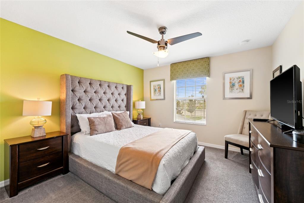 4841 Clock Tower Drive Kissimmee, FL 34746 - Photo 20 of 36 a bedroom with a bed and a flat screen tv