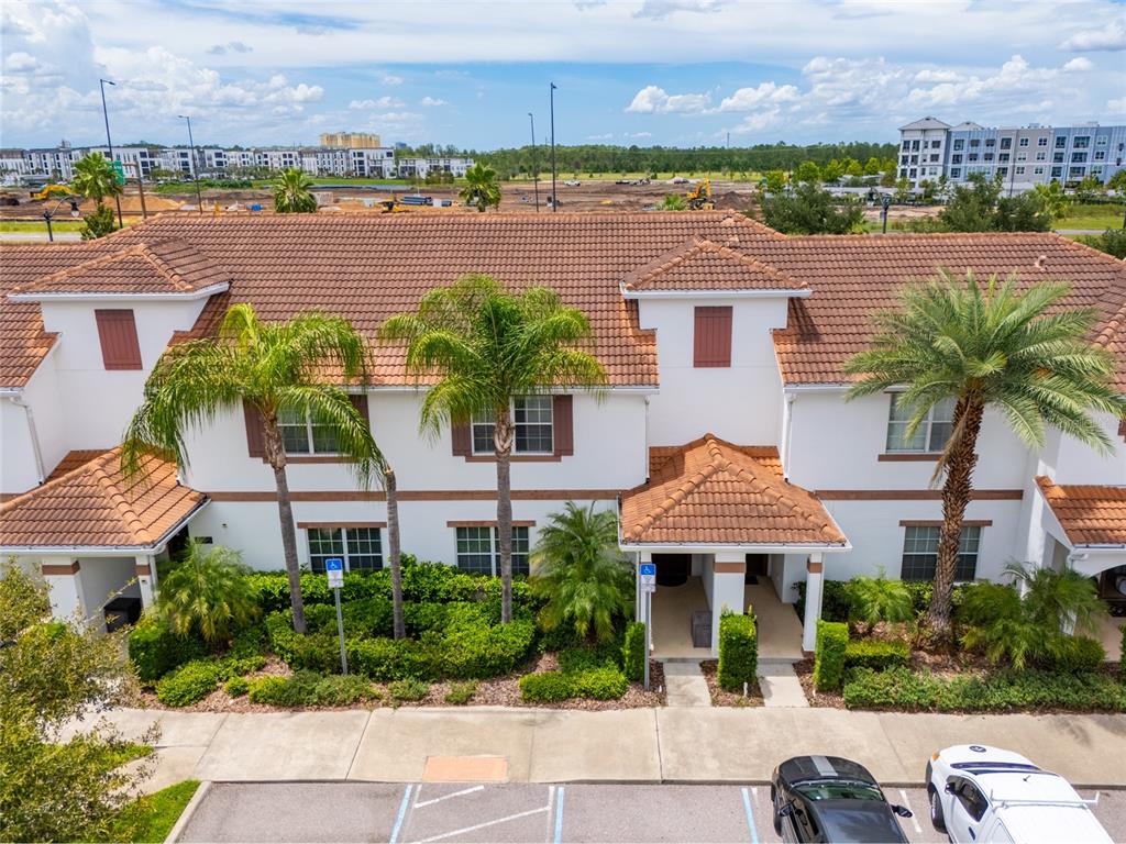 4841 Clock Tower Drive Kissimmee, FL 34746 - Photo 27 of 36 a front view of a house with garden and lake view
