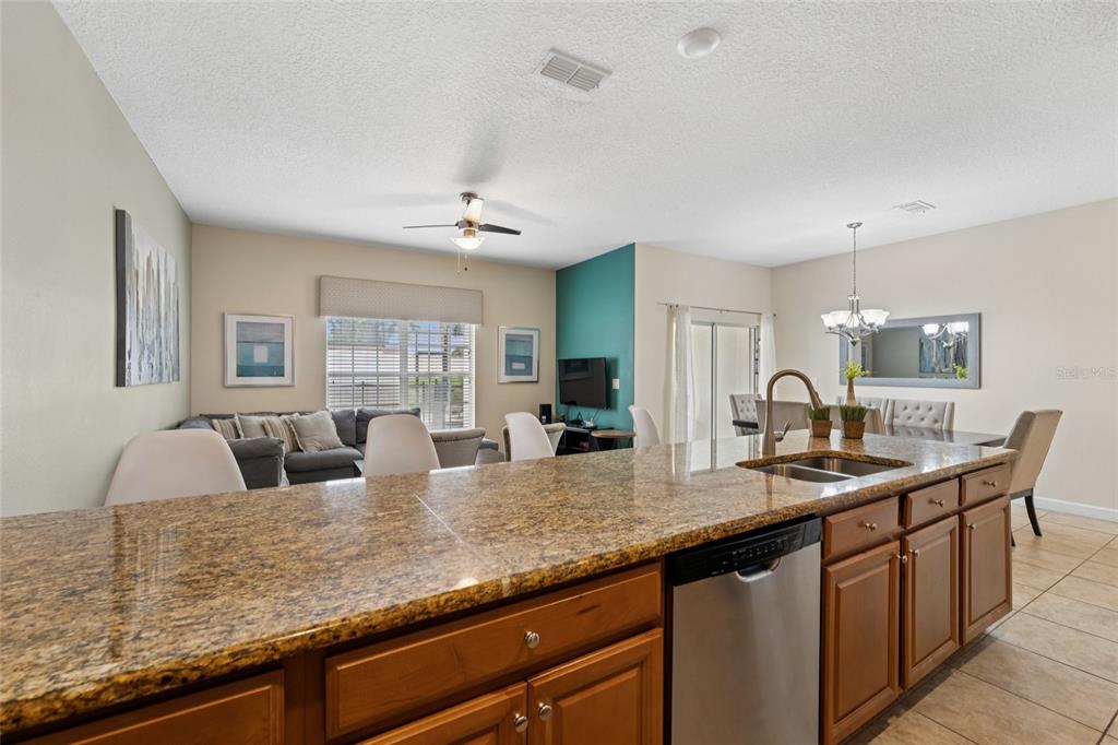 4841 Clock Tower Drive Kissimmee, FL 34746 - Photo 7 of 36 a kitchen with counter space a sink and cabinets