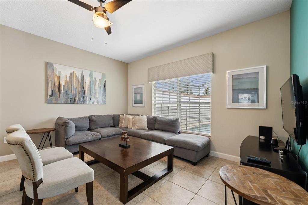 4841 Clock Tower Drive Kissimmee, FL 34746 - Photo 8 of 36 a living room with furniture and a flat screen tv