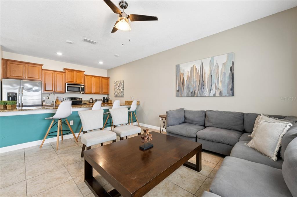 4841 Clock Tower Drive Kissimmee, FL 34746 - Photo 9 of 36 a living room with furniture and a open kitchen view