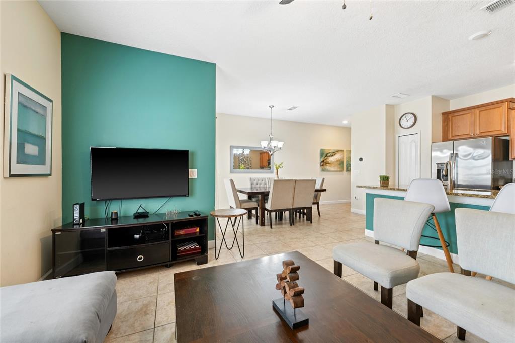 4841 Clock Tower Drive Kissimmee, FL 34746 - Photo 10 of 36 a living room with furniture and a flat screen tv