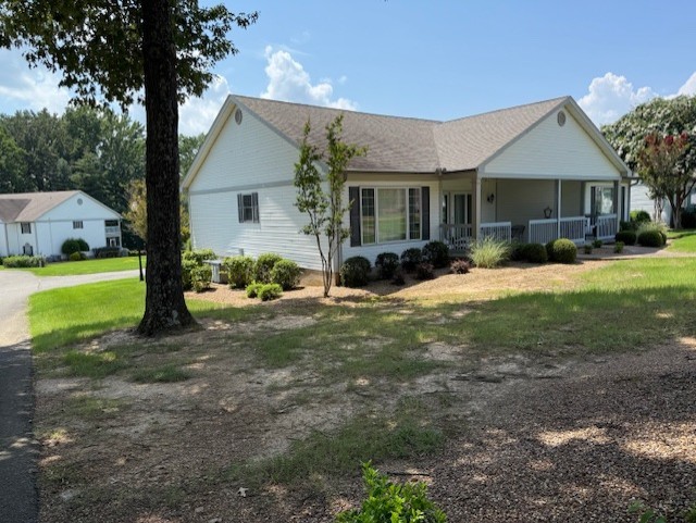 a view of a house with backyard and sitting area