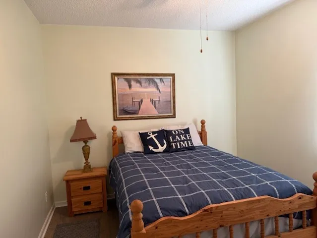 a bedroom with a bed and painting on the wall