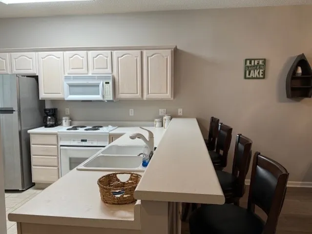 a kitchen with a table chairs and a refrigerator