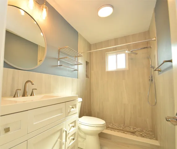 a bathroom with a sink toilet and shower