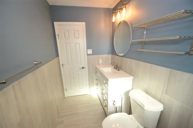 a bathroom with a toilet sink and mirror