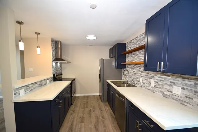 a kitchen with a sink appliances and cabinets