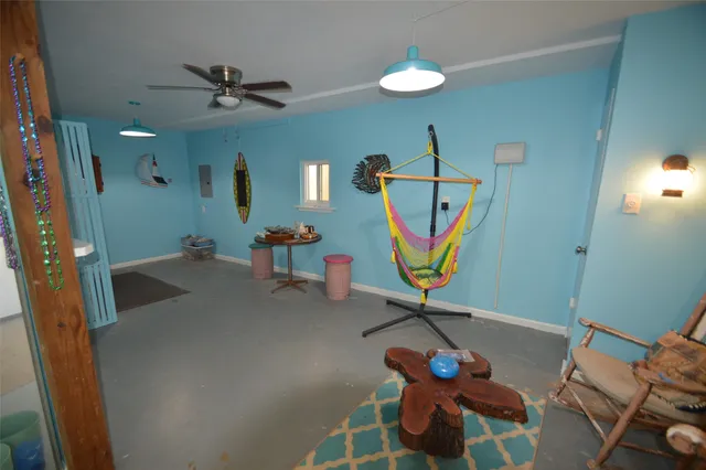 a living room with furniture and a gym equipment