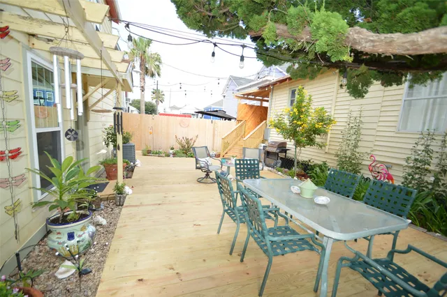 a view of a patio with table and chairs potted plants