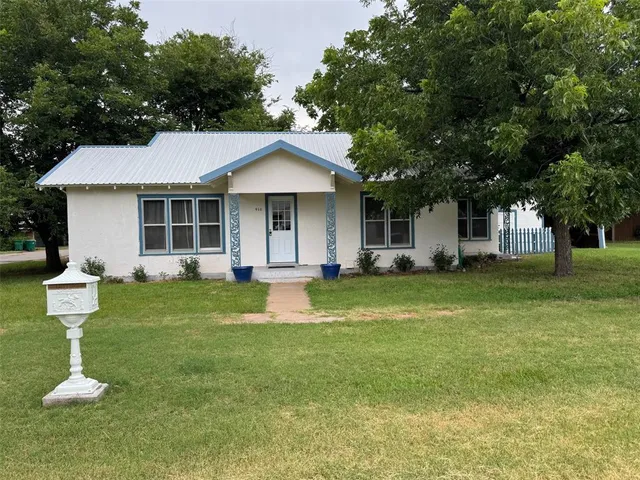 a front view of a house with a yard table and chairs