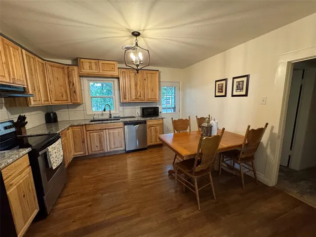 a view of a dining room with furniture and a chandelier
