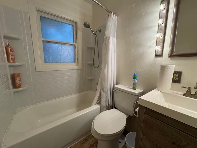 a bathroom with a sink toilet and shower