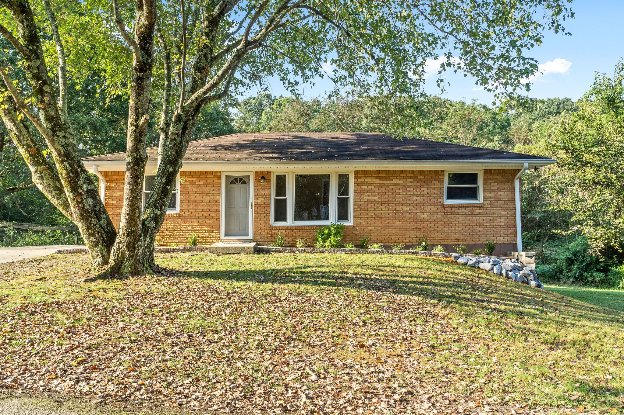 65 Locust Road Erin, TN 37061 - Photo 1 of 13 a front view of a house with a garden