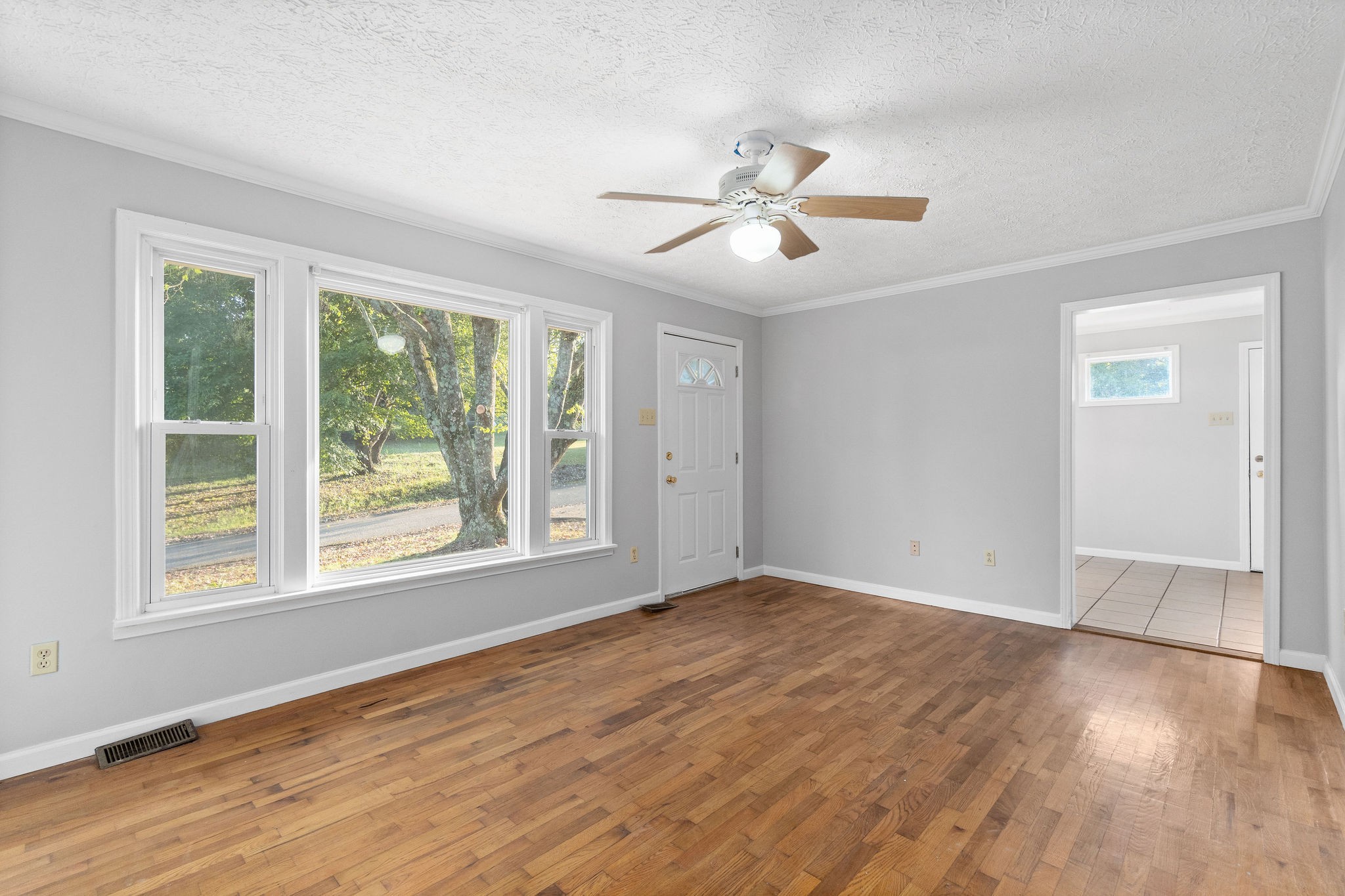 65 Locust Road Erin, TN 37061 - Photo 5 of 13 a view of empty room with wooden floor and fan