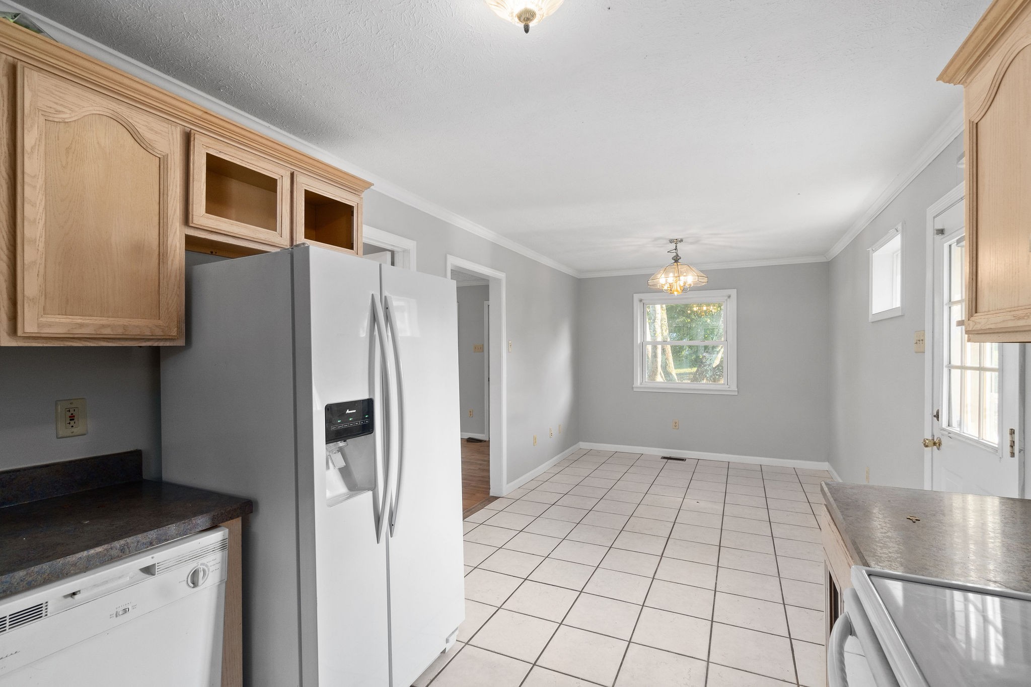 65 Locust Road Erin, TN 37061 - Photo 7 of 13 a kitchen with stainless steel appliances granite countertop a refrigerator and a stove top oven