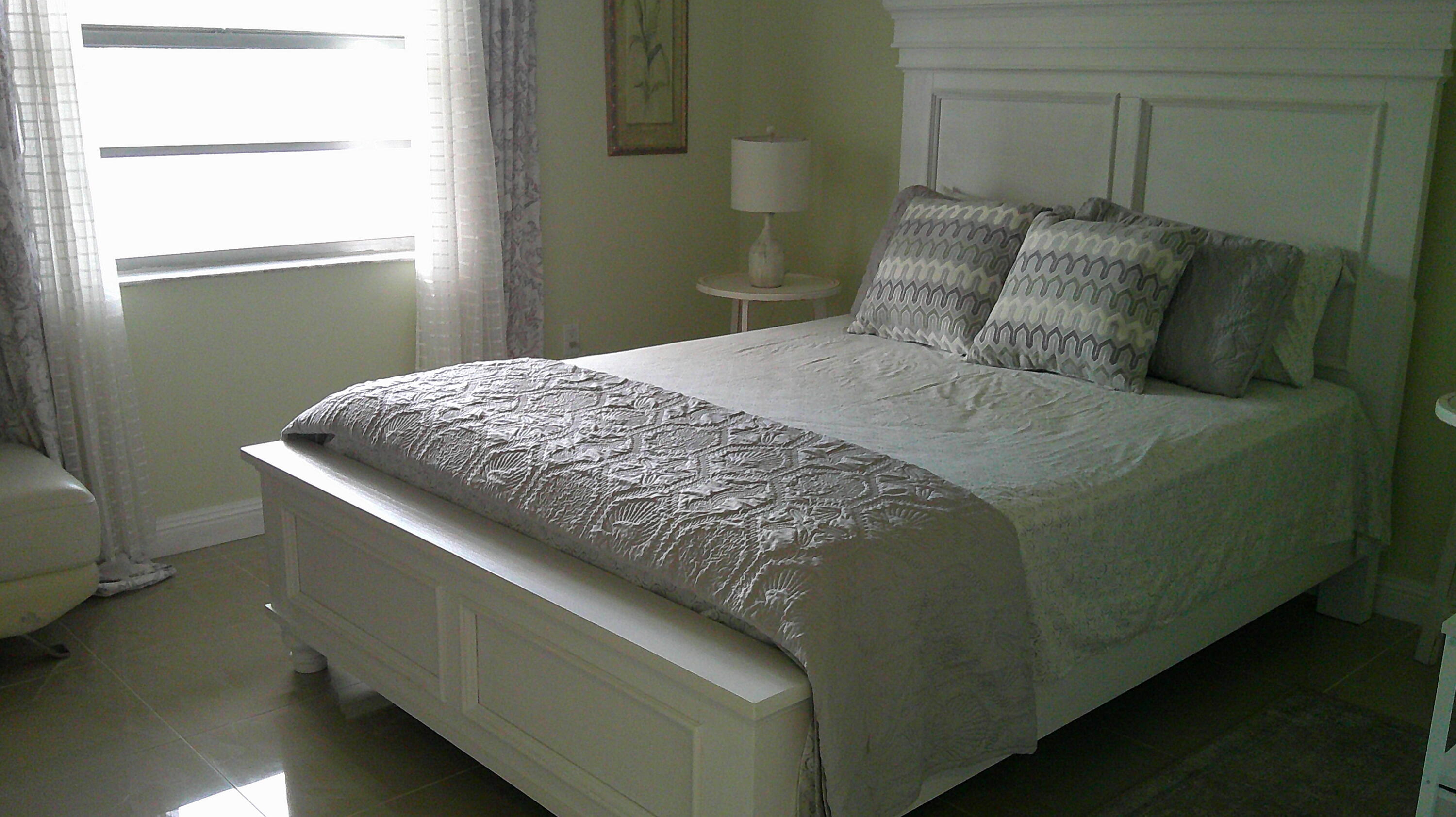 3940 Inverrary Boulevard, Unit 302A Lauderhill, FL 33319 - Photo 11 of 33 a bed sitting in a bedroom next to a window