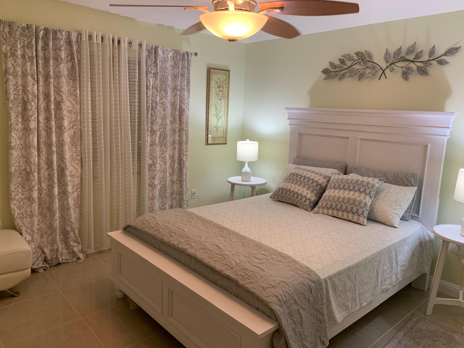3940 Inverrary Boulevard, Unit 302A Lauderhill, FL 33319 - Photo 13 of 33 a bedroom with a bed and a chandelier