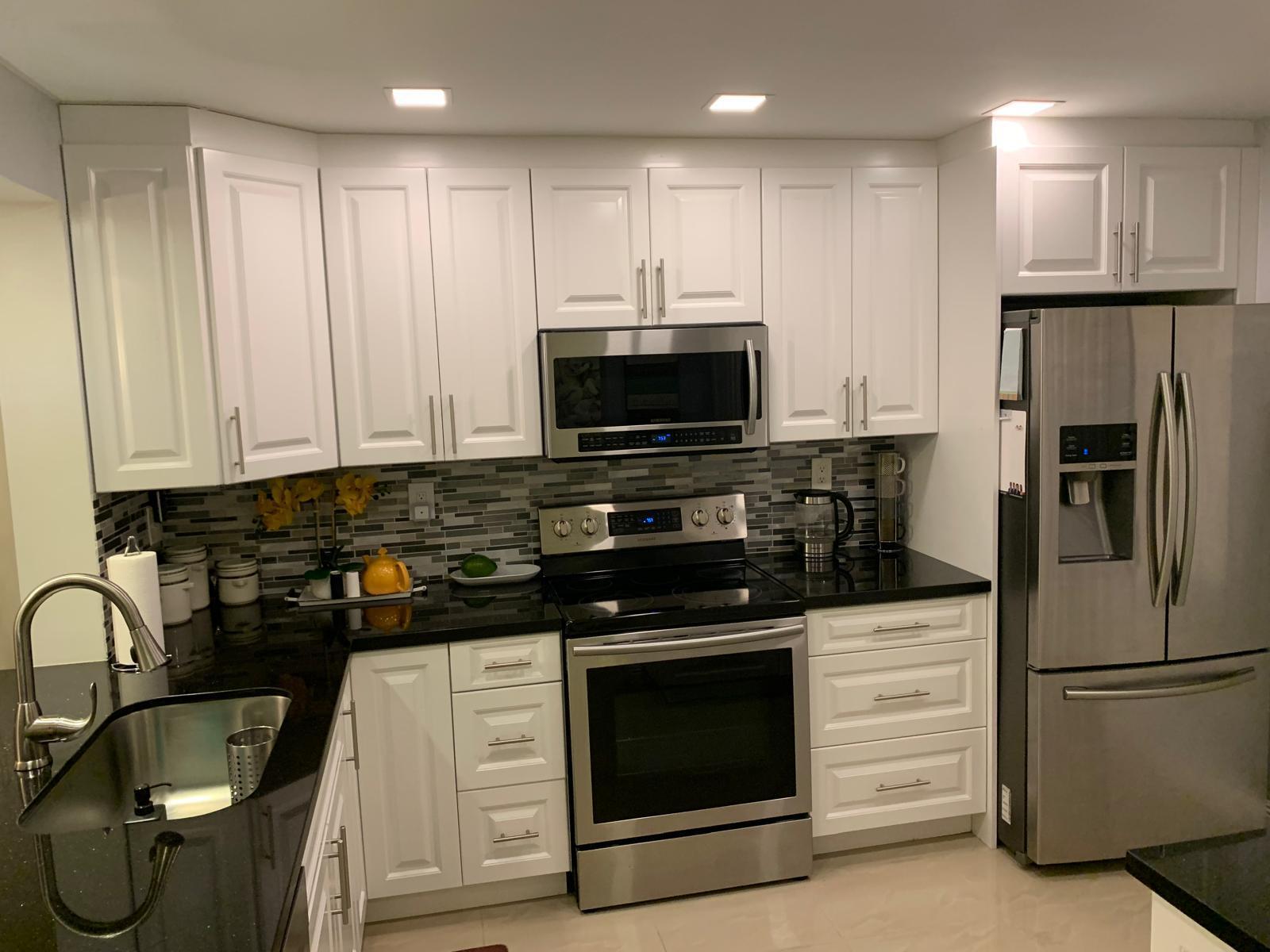 3940 Inverrary Boulevard, Unit 302A Lauderhill, FL 33319 - Photo 15 of 33 a kitchen with appliances a sink and cabinets