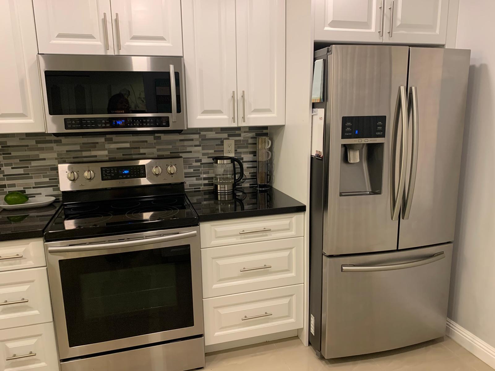 3940 Inverrary Boulevard, Unit 302A Lauderhill, FL 33319 - Photo 19 of 33 a kitchen with a refrigerator stove and microwave