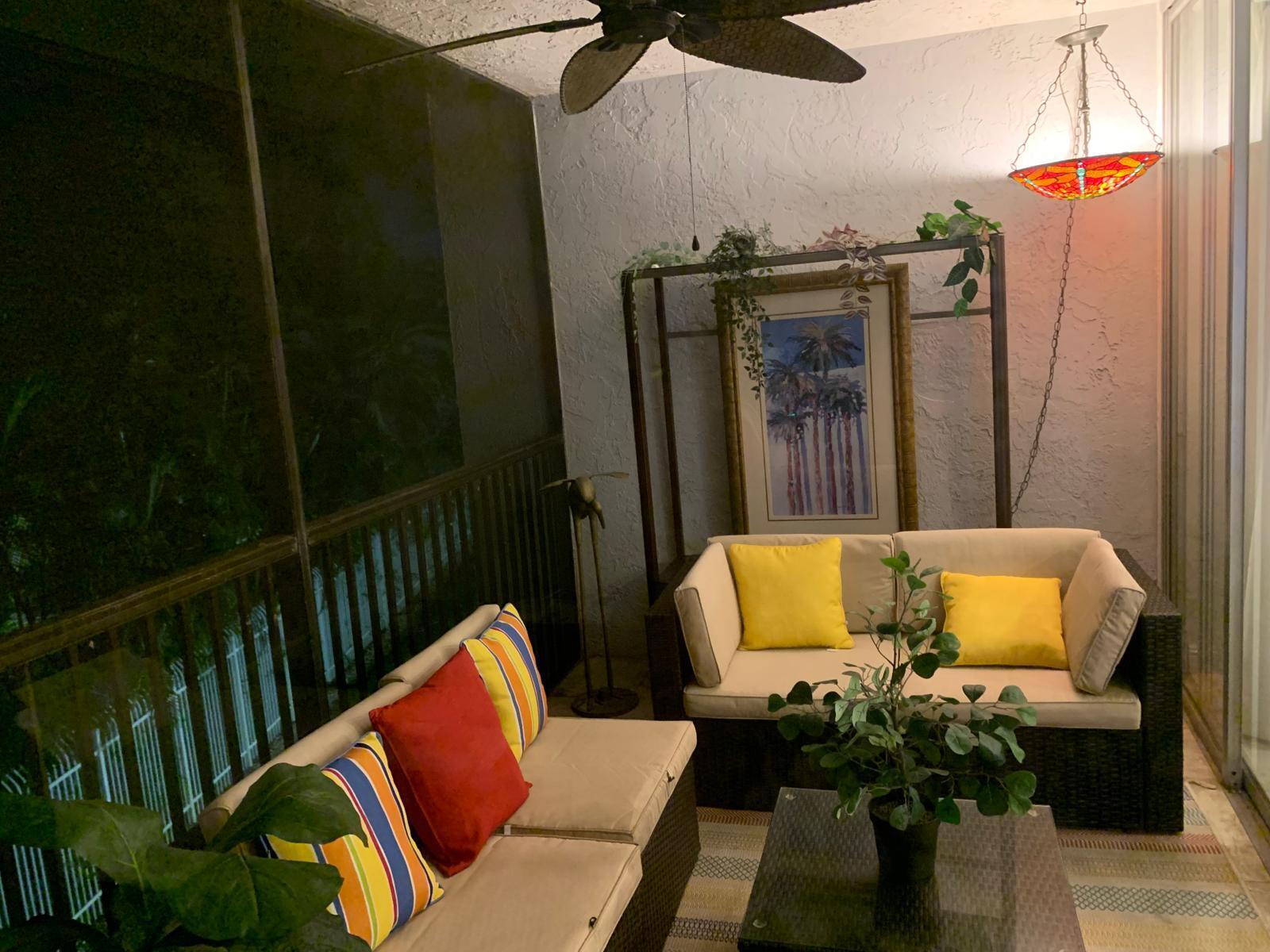 3940 Inverrary Boulevard, Unit 302A Lauderhill, FL 33319 - Photo 22 of 33 a couch sitting in a balcony next to a yard