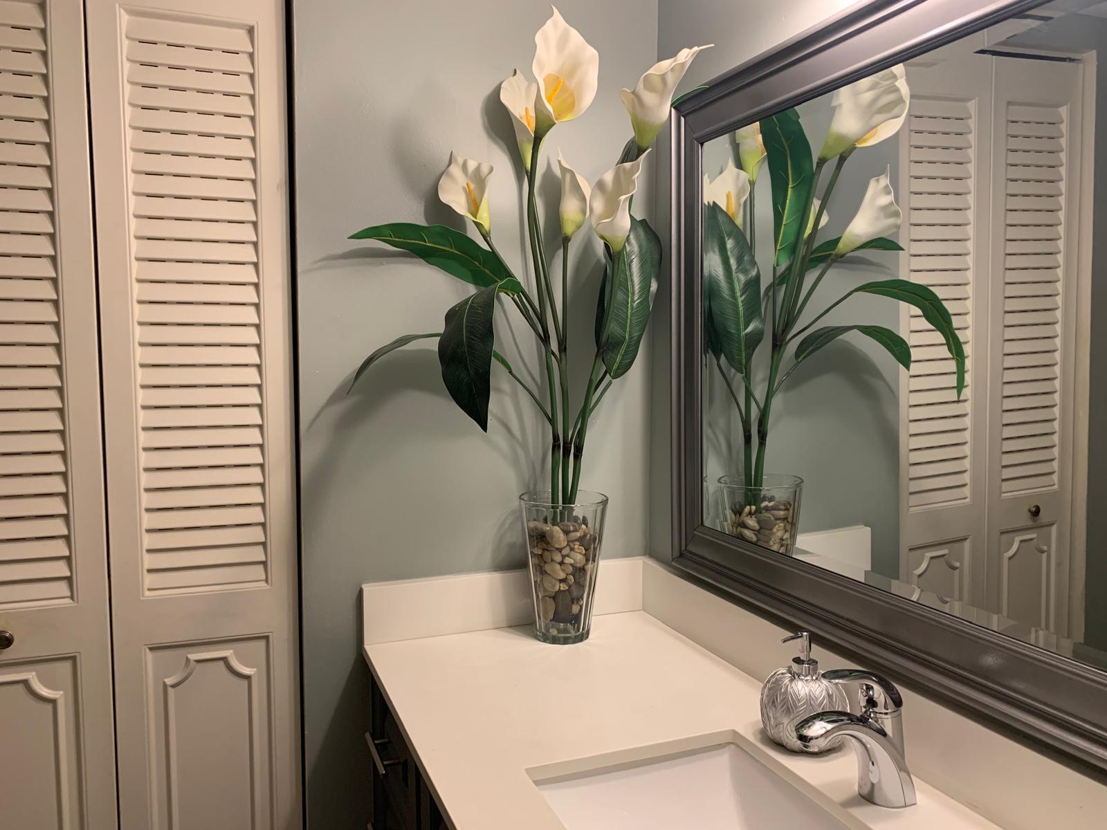 3940 Inverrary Boulevard, Unit 302A Lauderhill, FL 33319 - Photo 25 of 33 a view of a bathroom with a sink a mirror and a potted plant