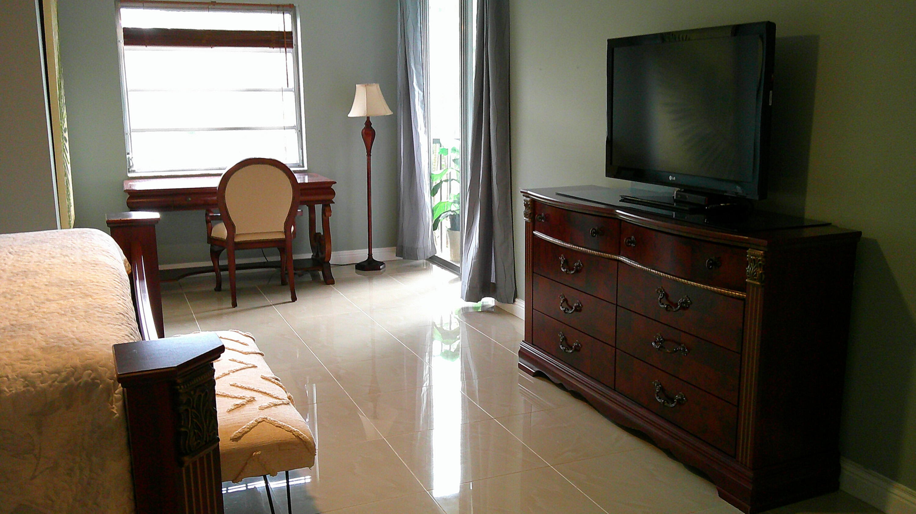 3940 Inverrary Boulevard, Unit 302A Lauderhill, FL 33319 - Photo 7 of 33 a living room with furniture and a flat screen tv