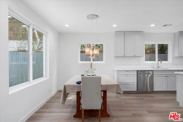 a dining room with wooden floor and a window