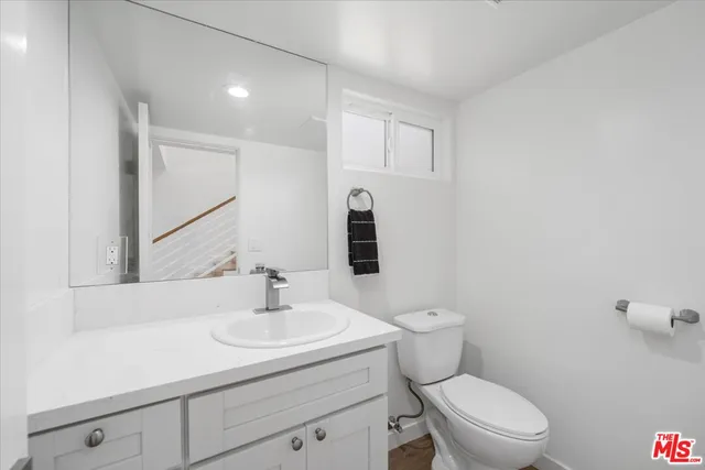 a bathroom with a sink toilet and mirror