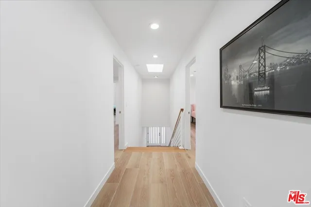 a view of a room with wooden floor and a ceiling fan