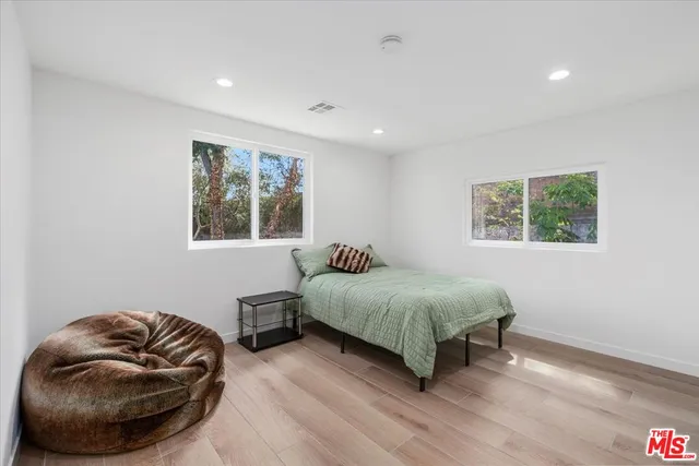 a bedroom with a bed and a couch