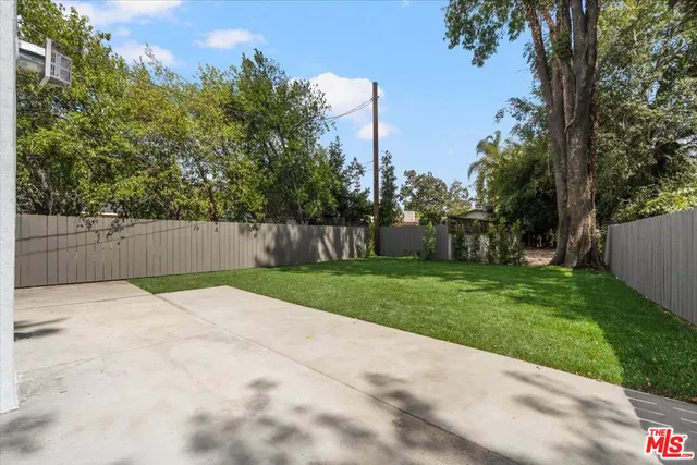 a white house that has tree in front of it