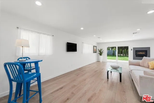 a living room with furniture a window and a flat screen tv