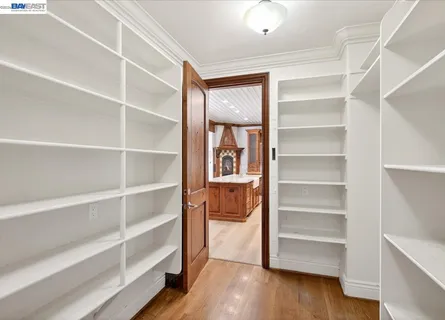 a large kitchen with stainless steel appliances granite countertop a stove a sink and a microwave