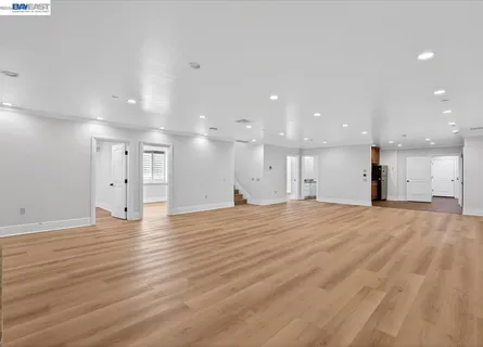 a view of walk in closet with wooden floor and a window