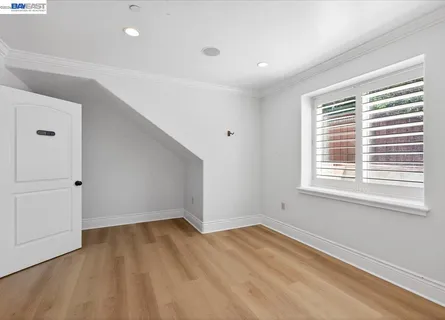 a kitchen with a wooden floor and a window