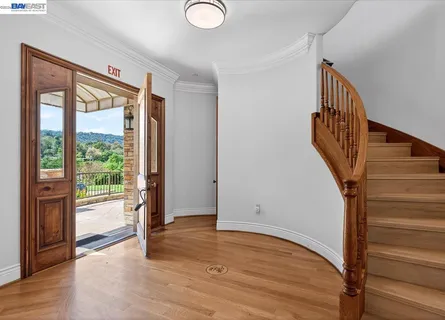 a view of an entryway with wooden floor and door
