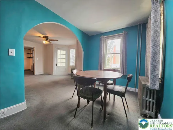 a view of a dining room with furniture and a window