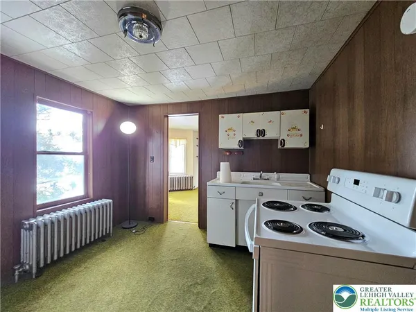 a kitchen with a stove and a refrigerator