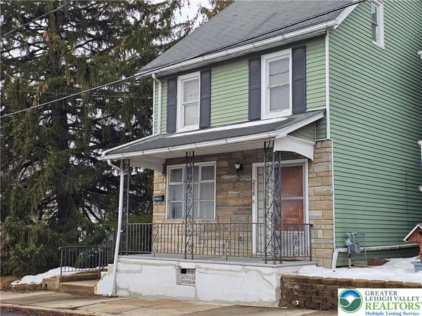 a view of brick house with large windows
