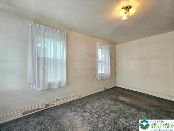 an empty room with a empty space and windows