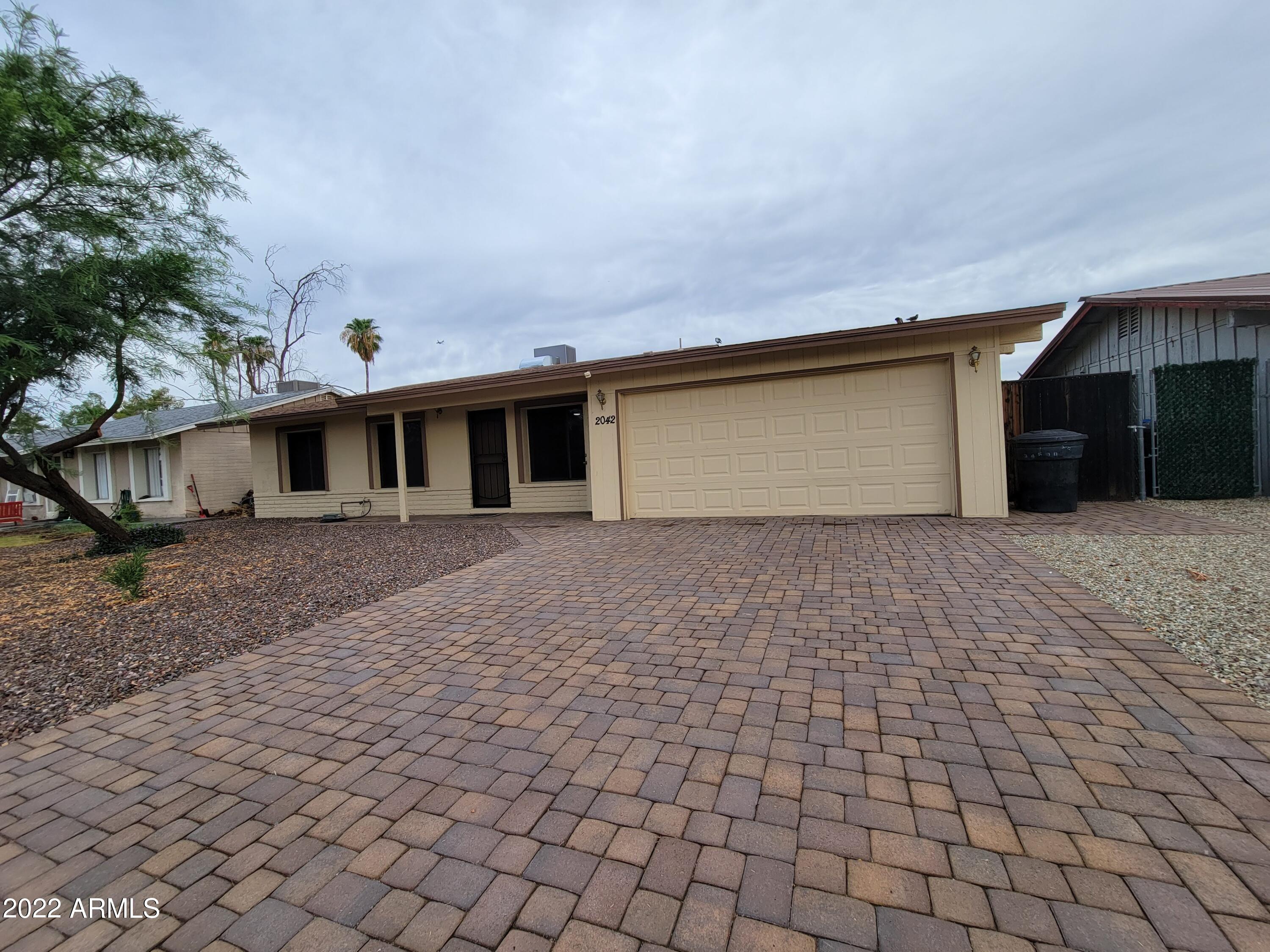 2042 West Decatur Street Mesa, AZ 85201 - Photo 1 of 38 a front view of a house with a yard