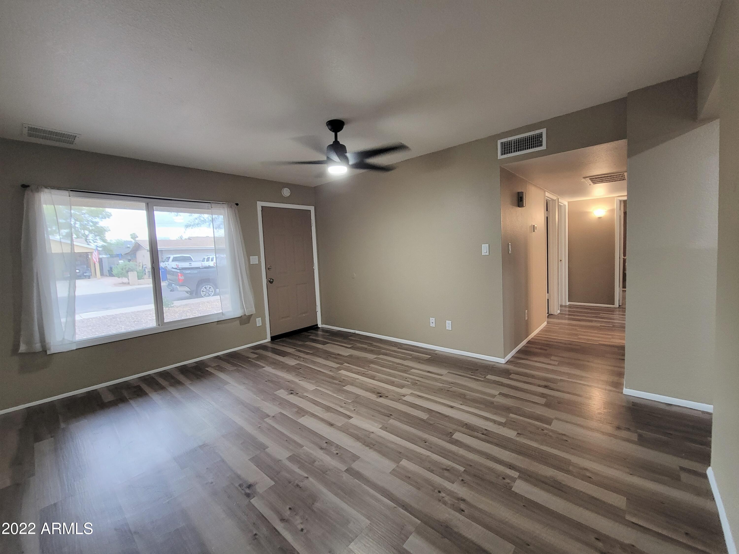 2042 West Decatur Street Mesa, AZ 85201 - Photo 13 of 38 a view of an empty room with glass door and wooden floor